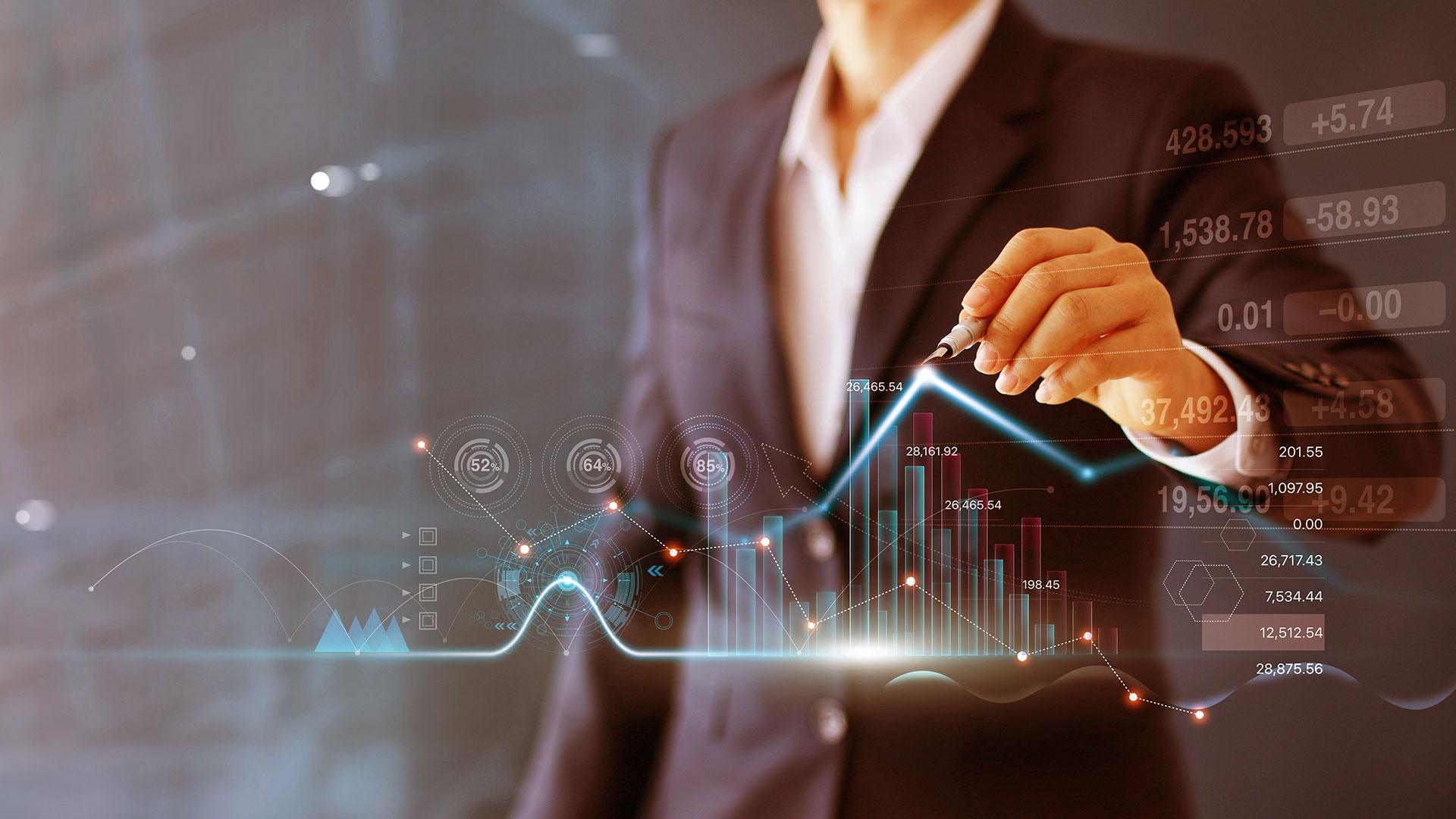 Businessman using computer with graph growth analysis on virtual